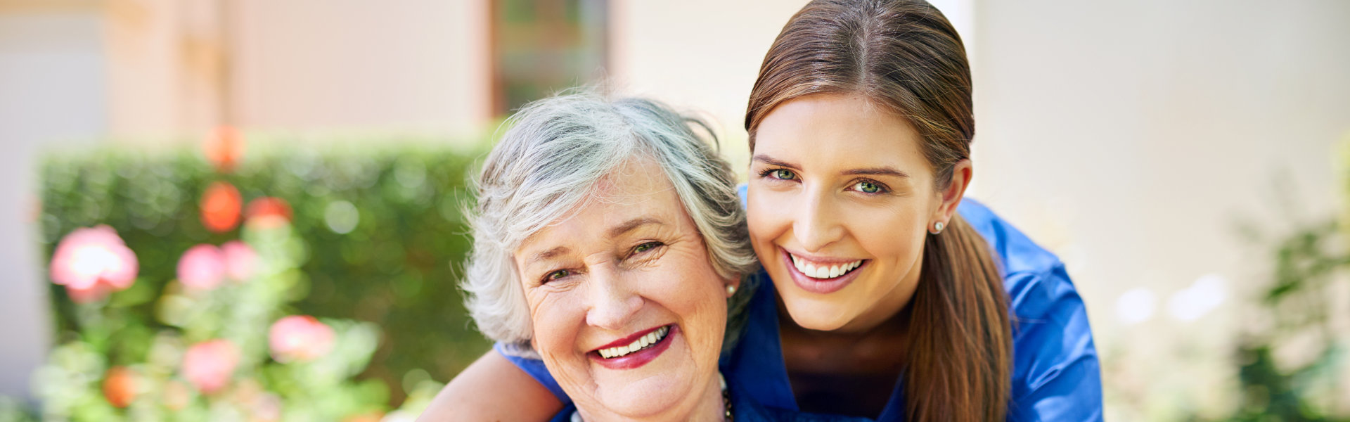 caregiver and senior woman smiling