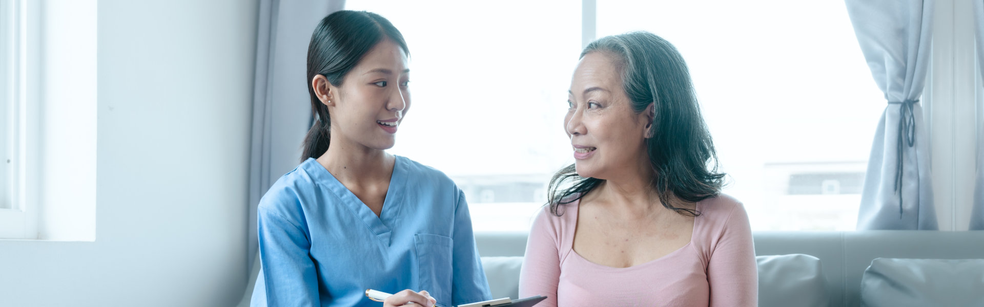 caregiver with pad and senior woman